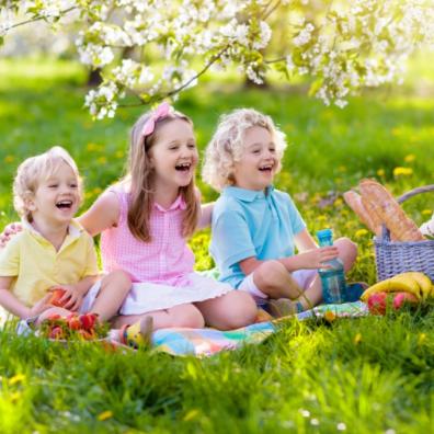 picture of happy children outside having a picnic