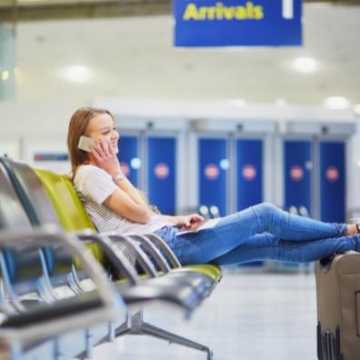picture of a woman on her phone at an airport