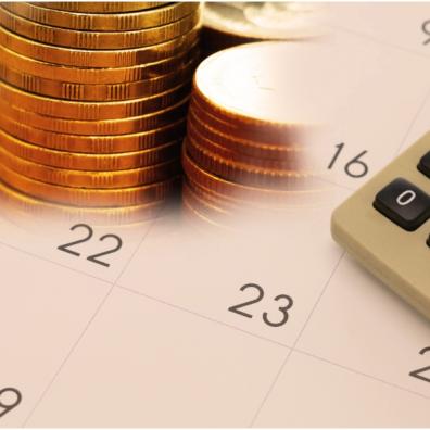 picture of money and calculator on a calendar 