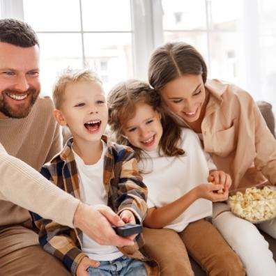 picture of happy family sat watching tv