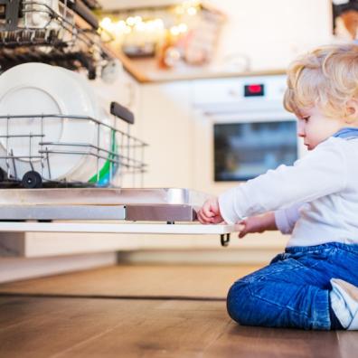 picture of a child looking in a dishwasher