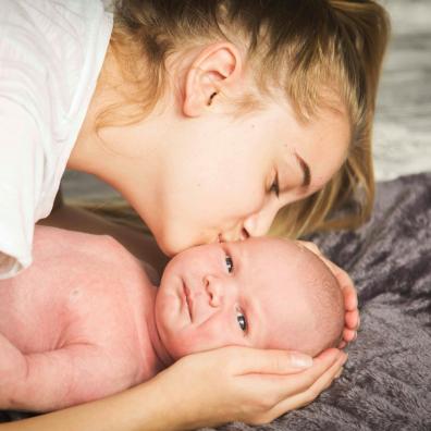 woman kissing baby