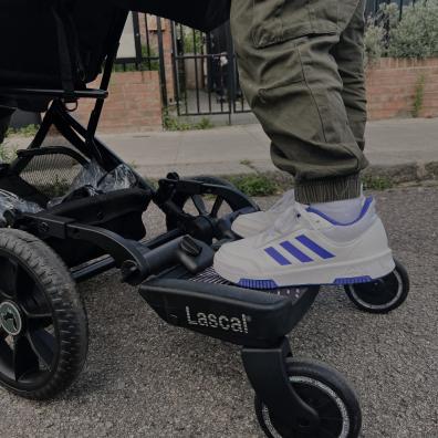 picture of a child standing on a Lascal buggy board attached to a pram