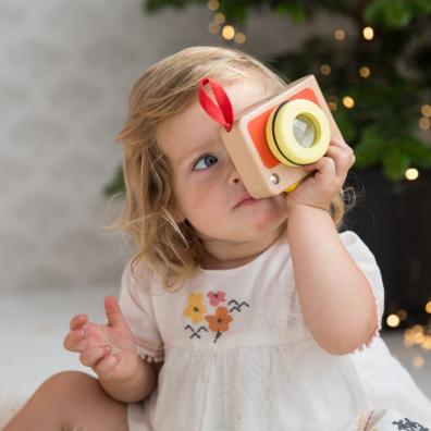 picture of a child playing with a My First Camera wooden toy