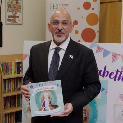 picture of Nadhim zahawi giving out free books to school children