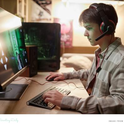 picture of a boy online gaming on a desktop computer in his bedroom