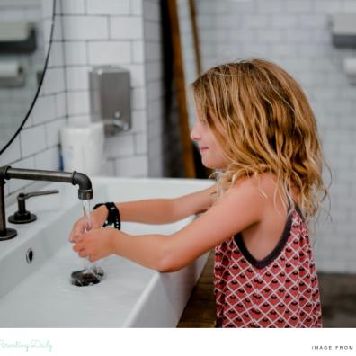 picture of a child washing her hands in a child friendly home bathroom