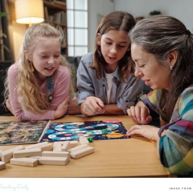picture of a family playing a board game to have screen free fun