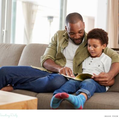 picture of a father and son building a love of reading by reading a book together