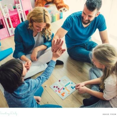 picture of a happy family enjoying plating a board game together at home