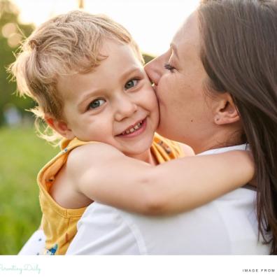 picture of a mum kissing her happy child on the cheek