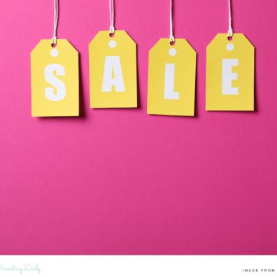picture of gift tags with the word sale written on in front of a pink background