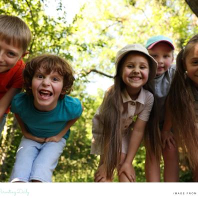 picture of happy children in a forest enjoying a walk in nature