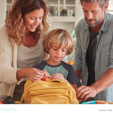 picture of parents helping their child pack their school bag as part of a evening routine