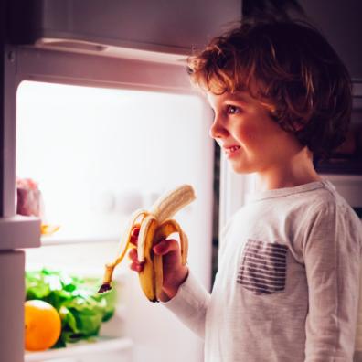 picture of a child eating a banana as a bedtime snack