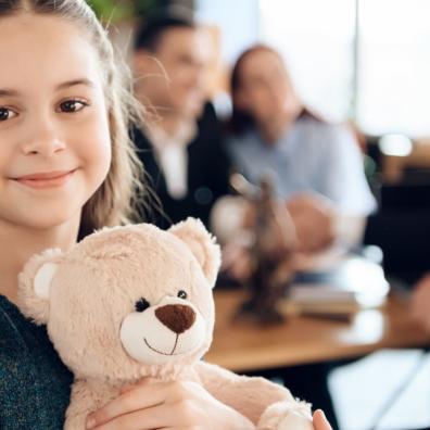 picture of a child holding a teddy in a family lawyers office