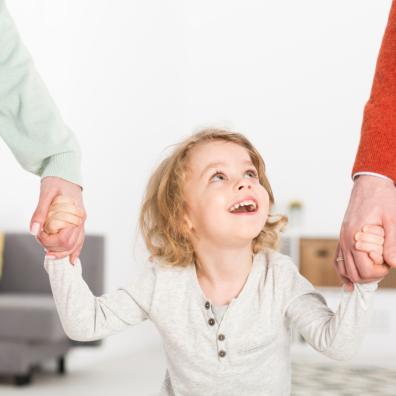 picture of child holding hands with adults