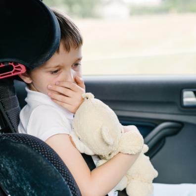 picture of a child in a car feeling travel sick