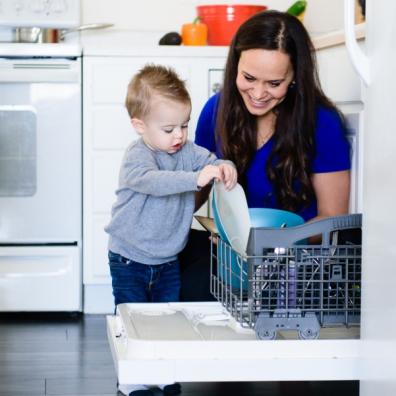 picture of a child loading the dishwasher