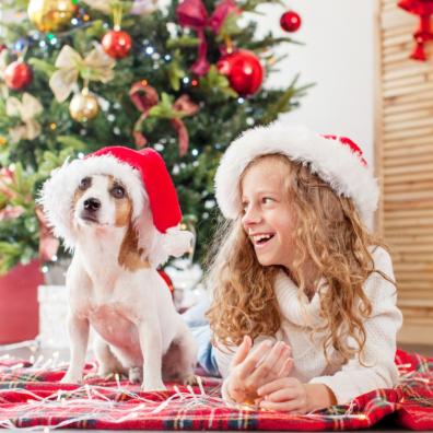 picture of a child with a dog at Christmas
