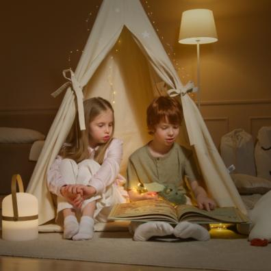 picture of children reading in a teepee