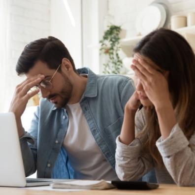 picture of couple looking at household bills
