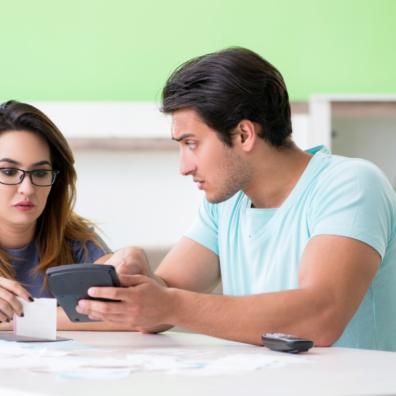picture of worried couple looking at their finances