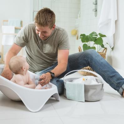 picture of a dad with baby in a baby bath