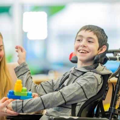 picture of disabled child and carer