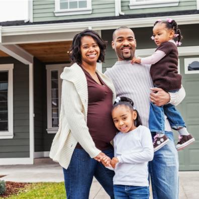 picture of a family outside a house