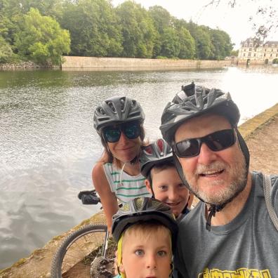 picture of a family on a cycling holiday by a river
