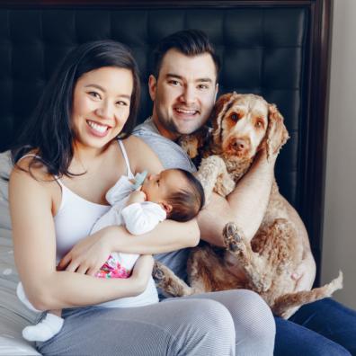 picture of family with new baby and a dog