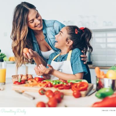 picture of a happy parent and child cooking healthy food