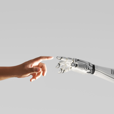 picture of a human hand touching a robotic hand