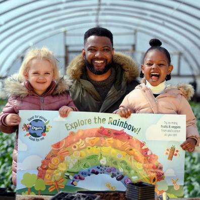 A picture of jb gill and two children promoting healthy eating in for kids