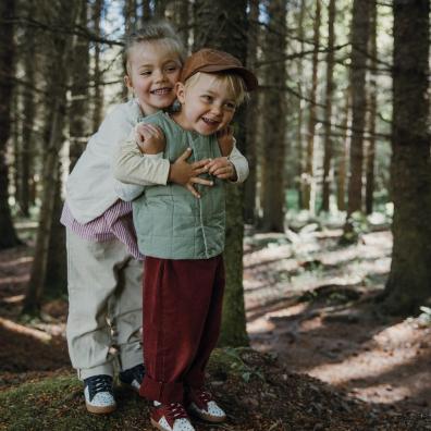 picture of children in the woods wearing pip and henry shoes