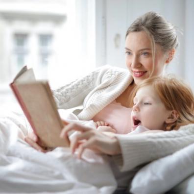 Picture of a mother and child reading a book together