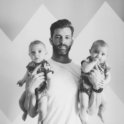 picture of a man holding two babies