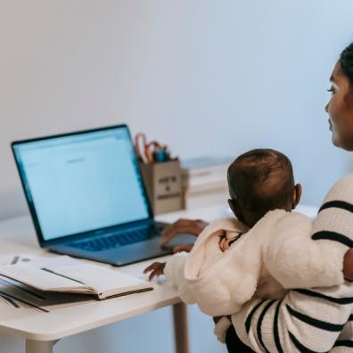 picture of a mum working from home with a baby on her lap