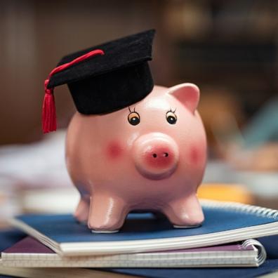 picture of a pink piggy bank with a student hat on
