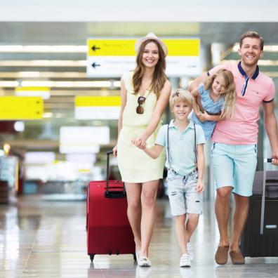 Happy family with suitcases in the airport