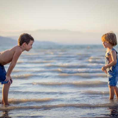picture of two children in the sea on holiday