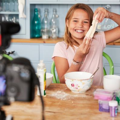 Picture of a child videoing herself doing some baking