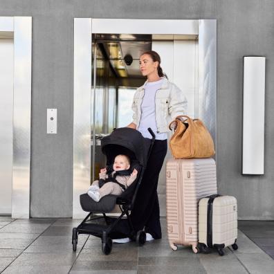picture of a mum and baby travelling using the Pisces Ultra Compact Stroller